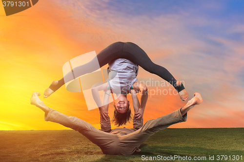 Image of The two people doing yoga exercises 