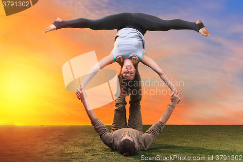 Image of The two people doing yoga exercises 