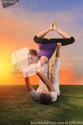 Image of The two people doing yoga exercises 