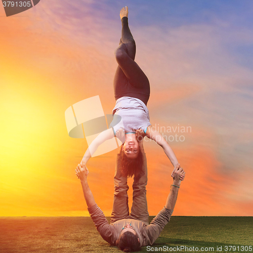 Image of The two people doing yoga exercises 
