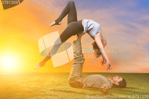 Image of The two people doing yoga exercises 