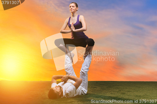 Image of The two people doing yoga exercises 