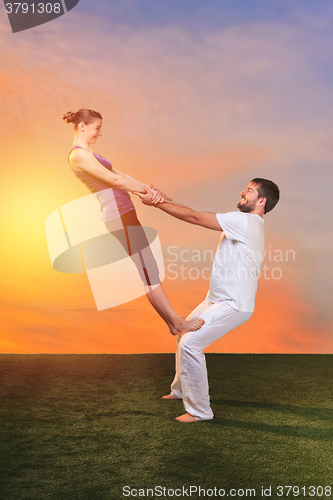 Image of The two people doing yoga exercises 