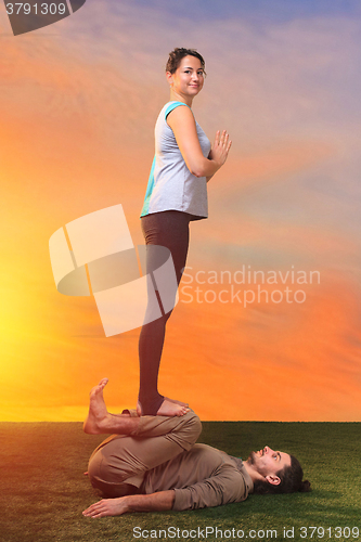 Image of The two people doing yoga exercises 