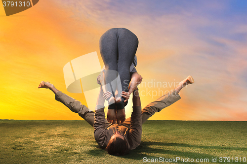 Image of The two people doing yoga exercises 