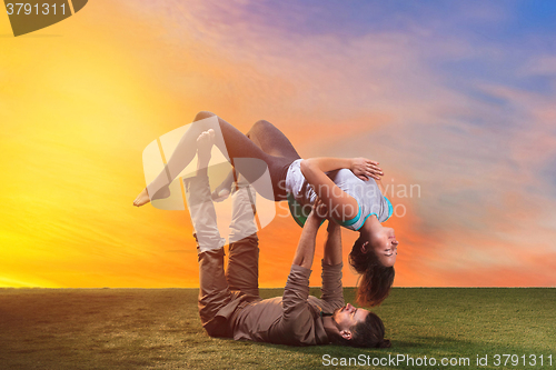 Image of The two people doing yoga exercises 