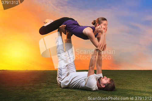 Image of The two people doing yoga exercises 
