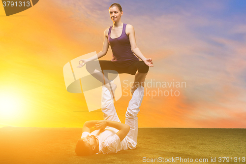 Image of The two people doing yoga exercises 