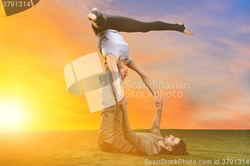 Image of The two people doing yoga exercises 