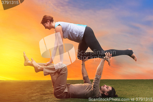 Image of The two people doing yoga exercises 