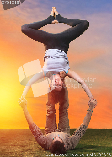 Image of The two people doing yoga exercises 