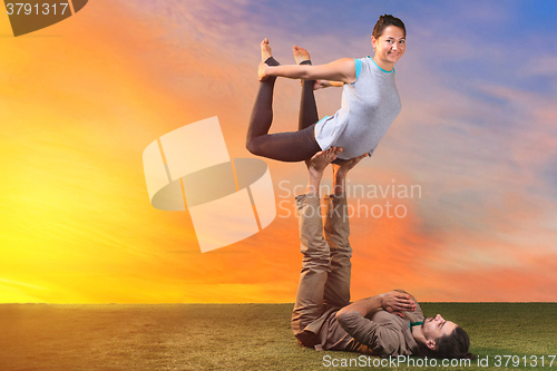 Image of The two people doing yoga exercises 