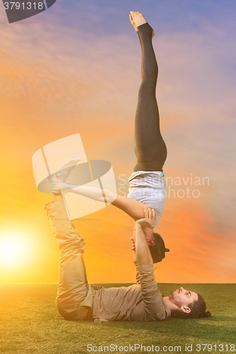 Image of The two people doing yoga exercises 