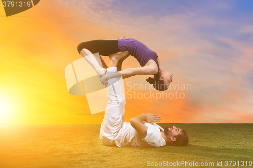 Image of The two people doing yoga exercises 