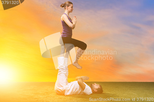 Image of The two people doing yoga exercises 