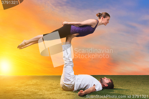 Image of The two people doing yoga exercises 