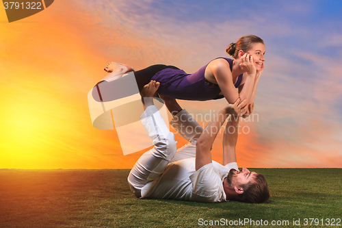 Image of The two people doing yoga exercises 