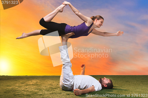 Image of The two people doing yoga exercises 