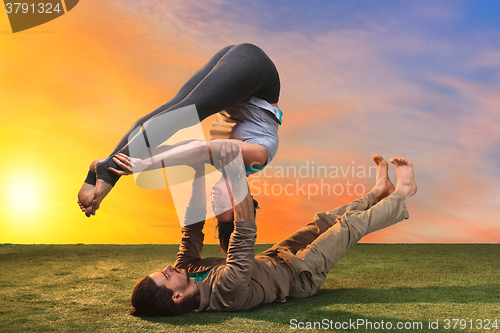 Image of The two people doing yoga exercises 