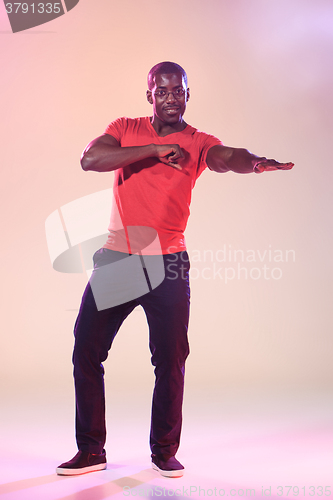 Image of The young cool black man is dancing