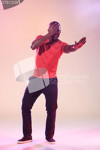 Image of The young cool black man is dancing