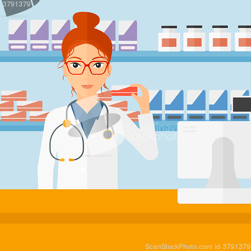 Image of Pharmacist showing some medicine.