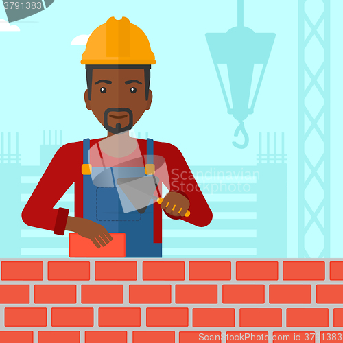 Image of Bricklayer with spatula and brick.