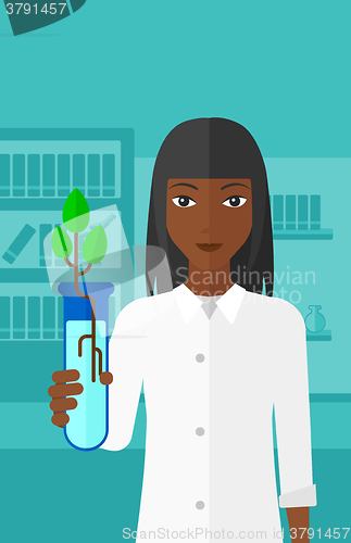 Image of Laboratory assistant with test tube.