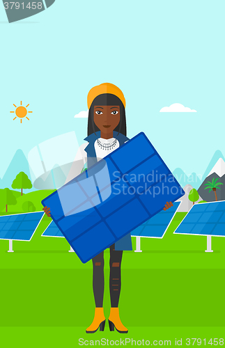 Image of Woman holding solar panel.