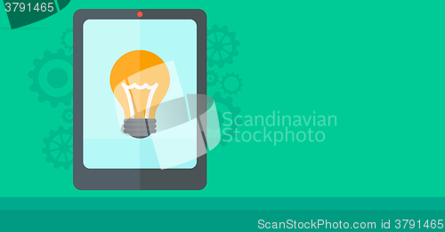 Image of Background of digital tablet with lightbulb.