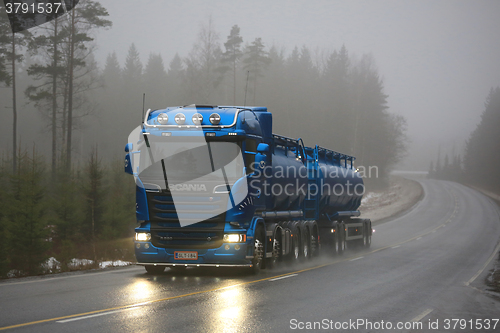 Image of Blue Scania R580 Tank Truck Pushes Forward in Fog