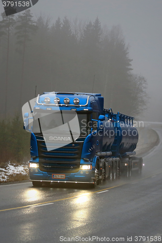 Image of Blue Scania R580 Tank Truck on Foggy Road, Vertical View