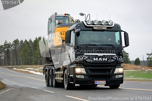 Image of MAN TGS 35.540 Truck Hauls Excavator