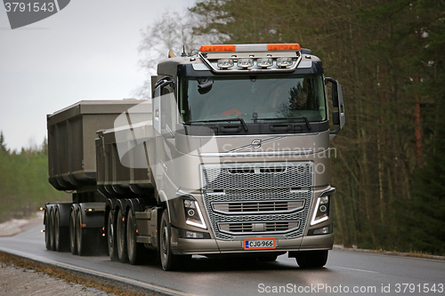 Image of Bronze Volvo FH16 Combination Truck on the Road