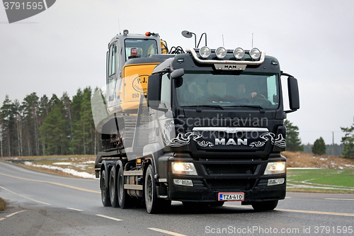 Image of MAN TGS 35.540 Truck Hauls Excavator