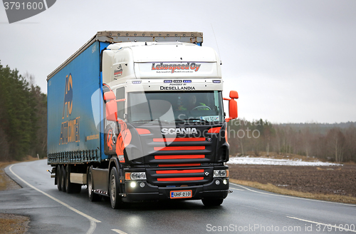 Image of Colorful Scania V8 Semi on Rural Road