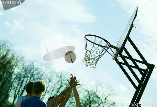 Image of People playing basketball outdoors