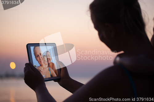 Image of Selfie of happy family on pad during vacation