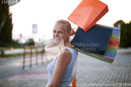 Image of Young woman outdoor excited at good shopping