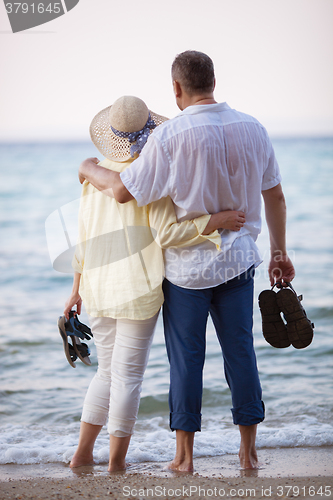 Image of Couple embracing and looking at sea