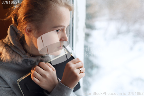 Image of Young girl in a deep thoughts