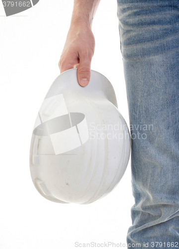 Image of Male engineer in jeans holding white hardhat