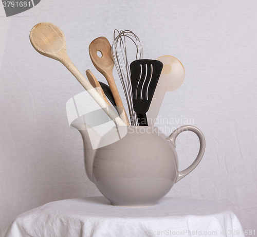 Image of Old teapot filled with spoons