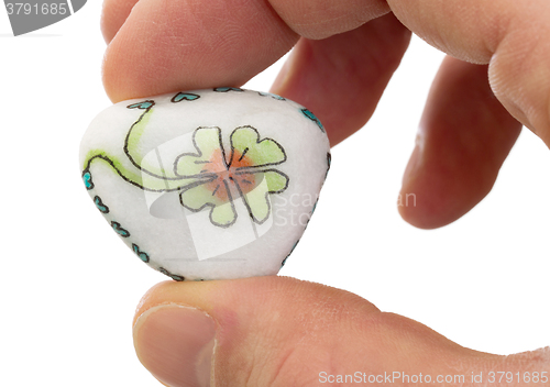 Image of Stone with drawing of a clover four and small hearts