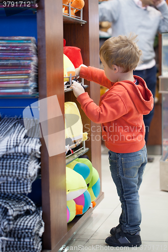 Image of Cute little boy shopping for a beach accessories