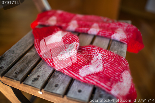 Image of Red woollen socks on wooden chair