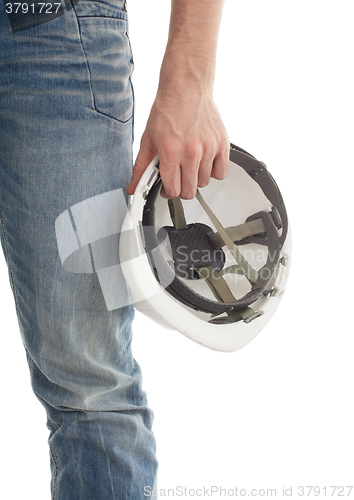 Image of Male engineer in jeans holding white hardhat