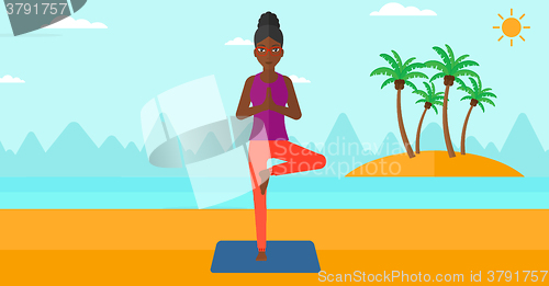 Image of Woman practicing yoga.