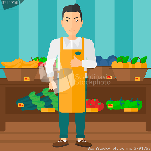 Image of Supermarket worker with box full of apples.