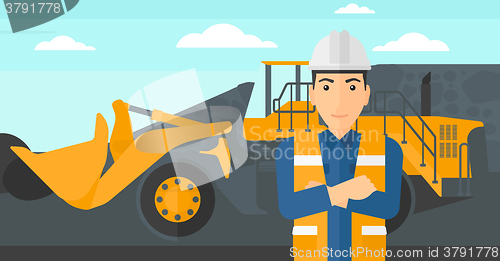 Image of Miner with mining equipment on background.